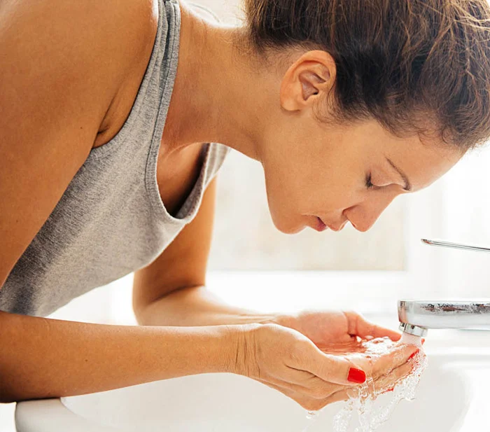 Woman applying sunscreen